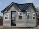 10x12 Custom Victorian Deluxe Storage Shed with vinyl siding, standing seam metal roofing, and additional windows